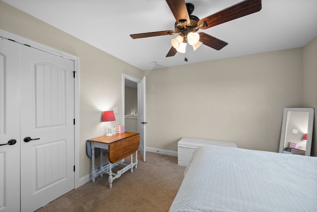 carpeted bedroom featuring ceiling fan and a closet