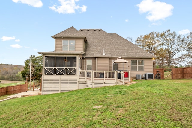 back of property featuring a gazebo, a lawn, and central AC unit