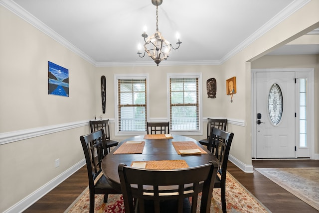 dining room with a chandelier, ornamental molding, and dark wood-type flooring