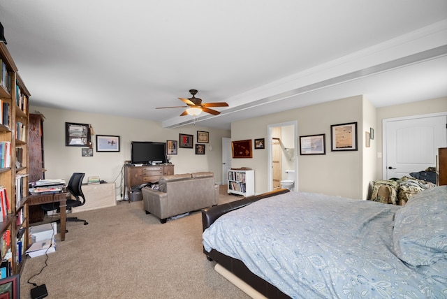 bedroom with ceiling fan, light colored carpet, and ensuite bath