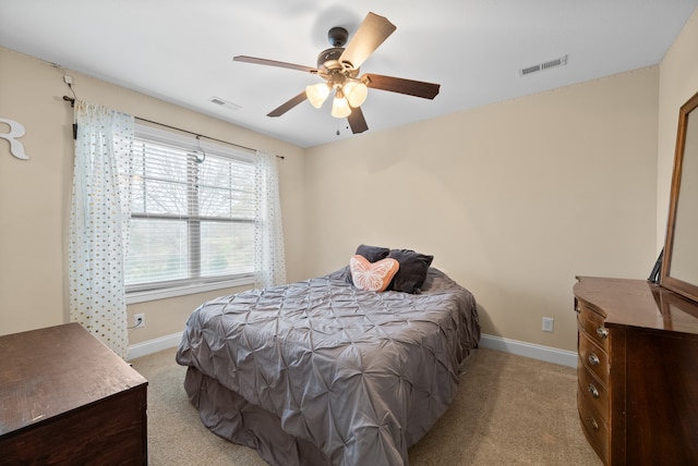 bedroom with ceiling fan and light carpet