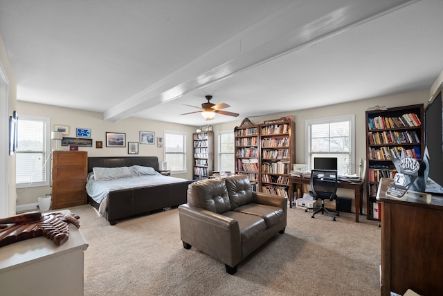 carpeted bedroom featuring ceiling fan, beam ceiling, and multiple windows