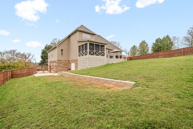 rear view of property featuring a lawn and a sunroom