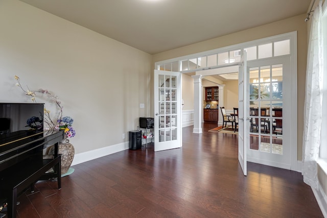 misc room with ornate columns, dark hardwood / wood-style flooring, and french doors