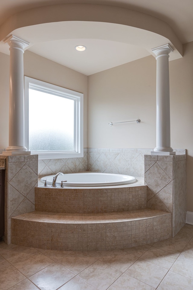 bathroom with tile patterned flooring and tiled tub