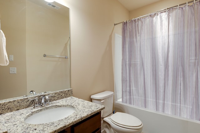 full bathroom with shower / tub combo with curtain, vanity, and toilet