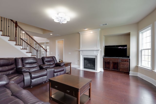 living room with a chandelier and dark hardwood / wood-style floors