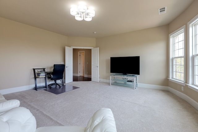 living room featuring carpet and plenty of natural light