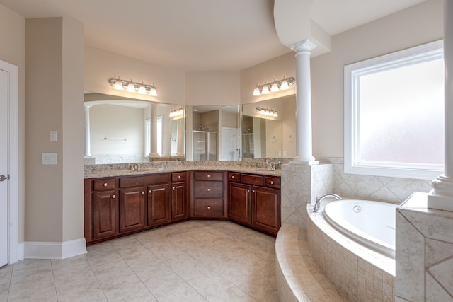 bathroom featuring tile patterned floors, vanity, shower with separate bathtub, and decorative columns