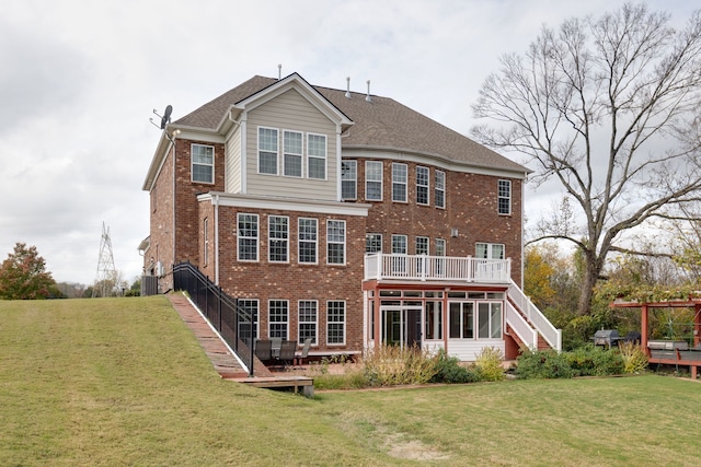 rear view of house featuring a yard