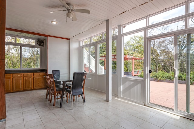 sunroom featuring ceiling fan and wooden ceiling