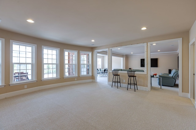 carpeted living room featuring crown molding