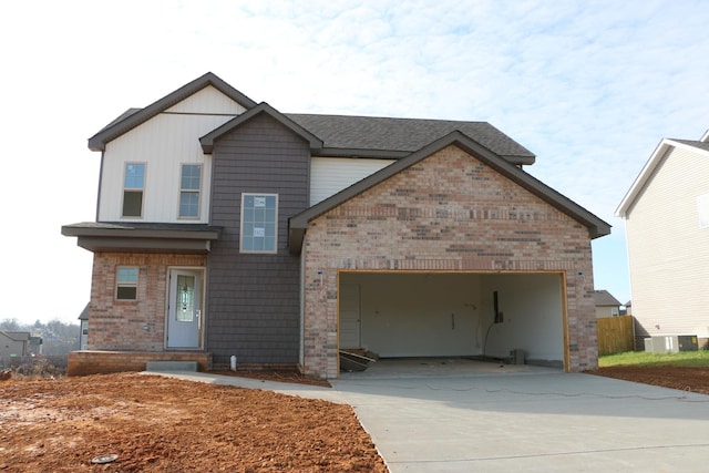 view of front of property featuring cooling unit and a garage