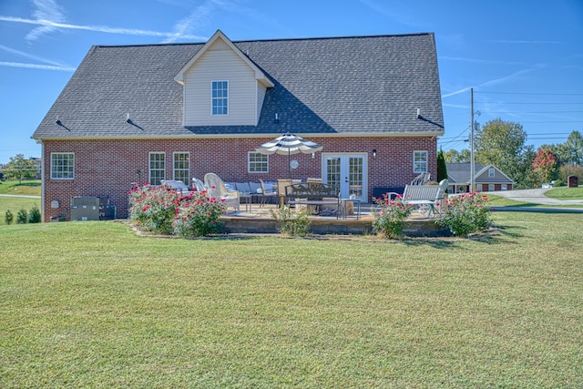 rear view of house featuring a lawn and a patio