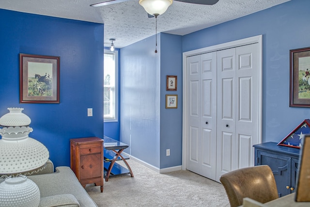 office with ceiling fan, carpet floors, and a textured ceiling