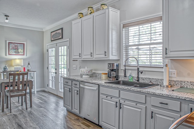 kitchen with french doors, stainless steel dishwasher, ornamental molding, a textured ceiling, and sink