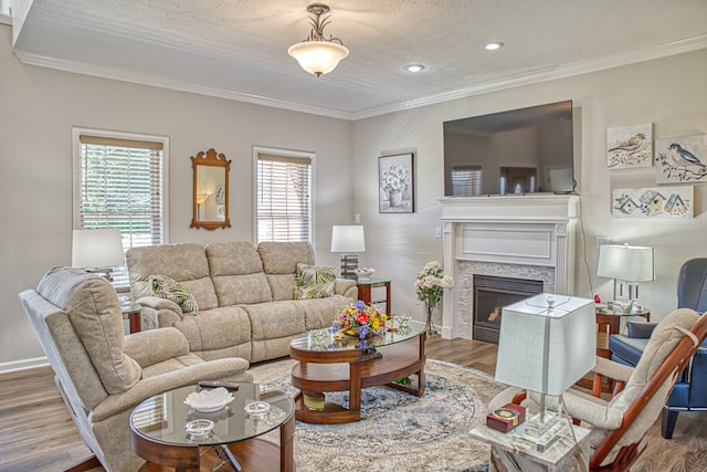 living room with wood-type flooring, a wealth of natural light, and crown molding