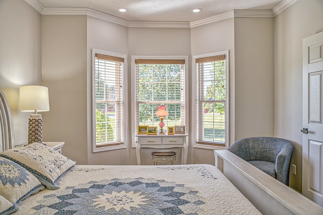 bedroom with ornamental molding, a textured ceiling, and multiple windows