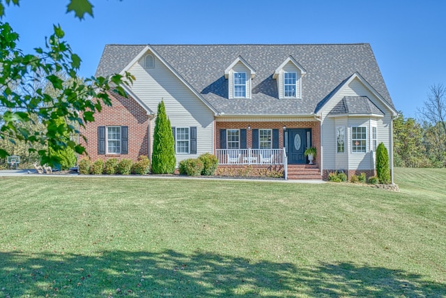 cape cod-style house with a front lawn and covered porch