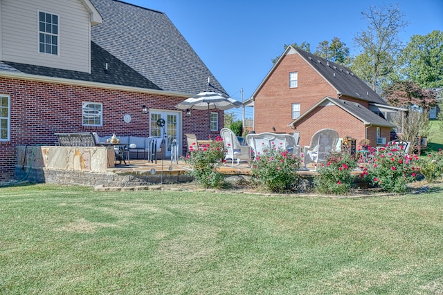 rear view of property with a yard and a patio