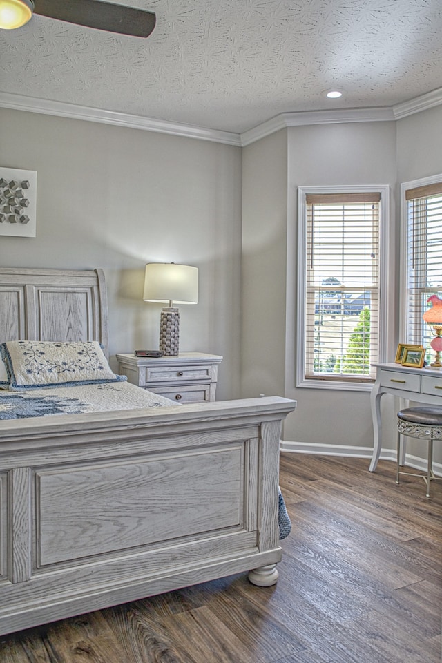 bedroom featuring a textured ceiling, dark hardwood / wood-style floors, and ornamental molding