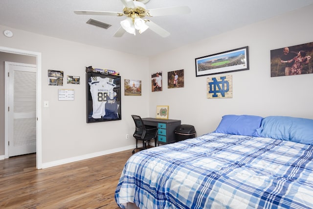 bedroom with ceiling fan and wood-type flooring