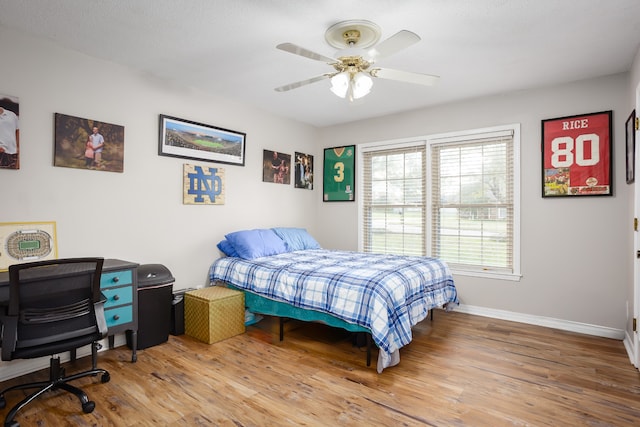 bedroom with ceiling fan and hardwood / wood-style floors