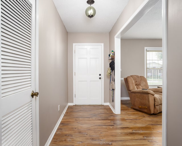 foyer entrance featuring hardwood / wood-style floors and a textured ceiling