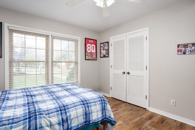 bedroom with ceiling fan, a closet, and hardwood / wood-style floors