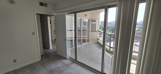 doorway with hardwood / wood-style flooring