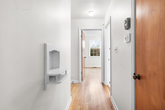 hall with light hardwood / wood-style floors