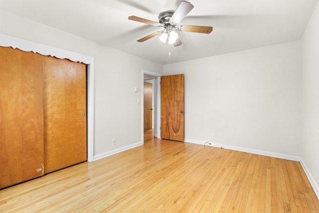 unfurnished bedroom featuring a closet, light hardwood / wood-style flooring, and ceiling fan