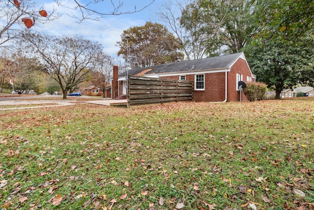 view of side of property with a lawn