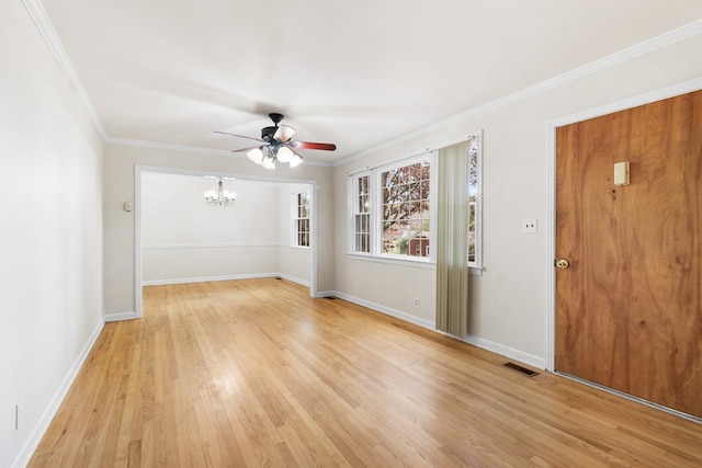 empty room with ceiling fan with notable chandelier, crown molding, and light hardwood / wood-style flooring