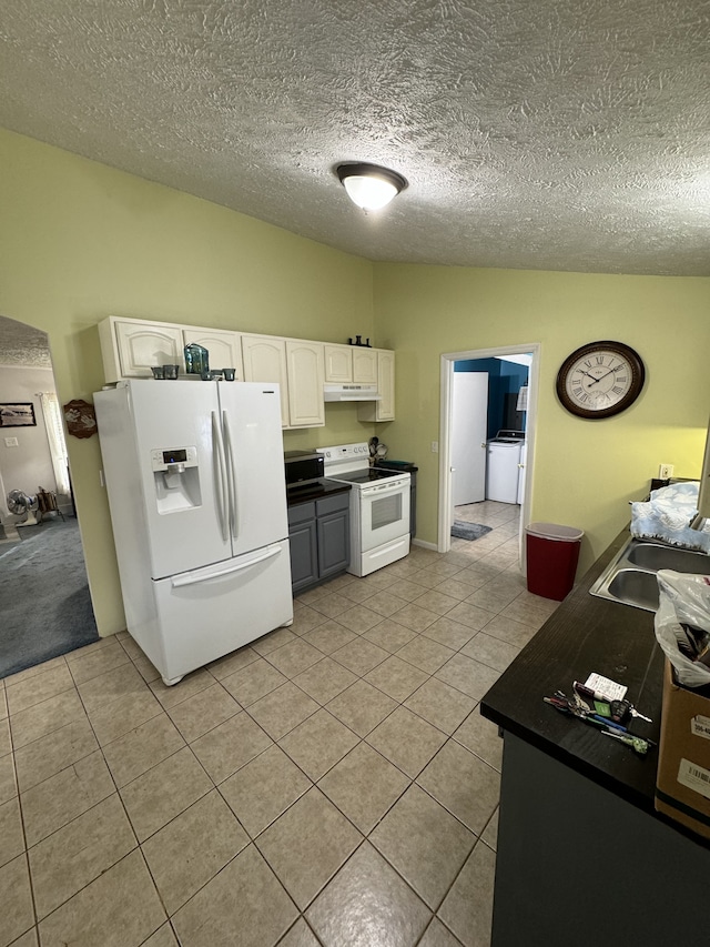 kitchen with white cabinetry, sink, a textured ceiling, white appliances, and light tile patterned flooring