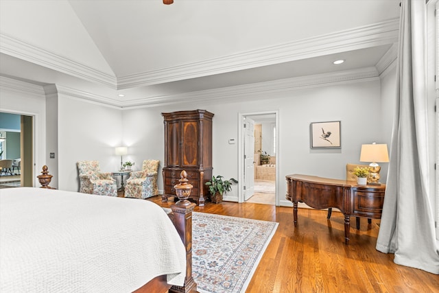 bedroom with ensuite bathroom, ornamental molding, vaulted ceiling, and hardwood / wood-style flooring