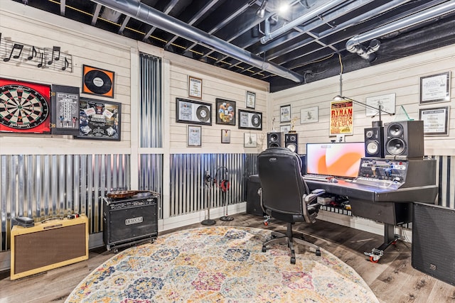 office with hardwood / wood-style flooring and wooden walls