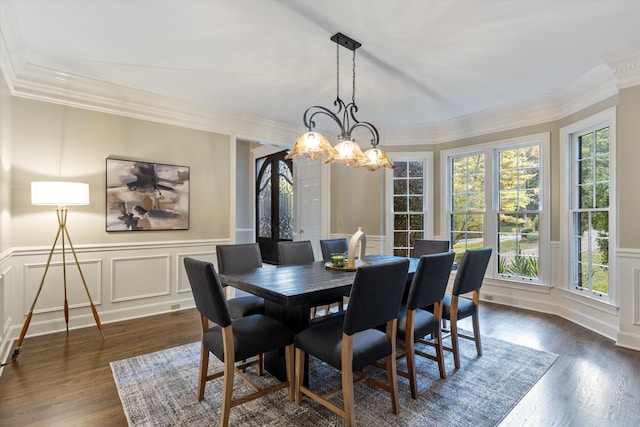 dining room with dark hardwood / wood-style floors, crown molding, and a notable chandelier