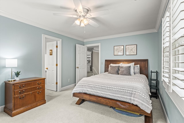 carpeted bedroom featuring ceiling fan and crown molding