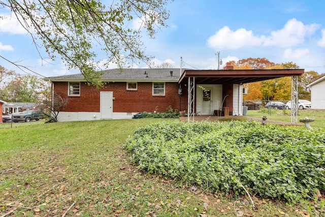 rear view of property with a yard