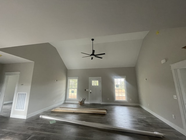 unfurnished living room with ceiling fan, dark hardwood / wood-style flooring, high vaulted ceiling, and plenty of natural light