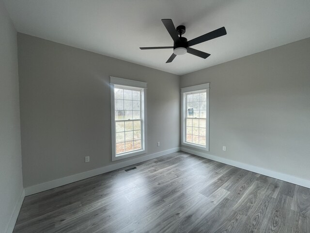 empty room featuring ceiling fan and hardwood / wood-style flooring