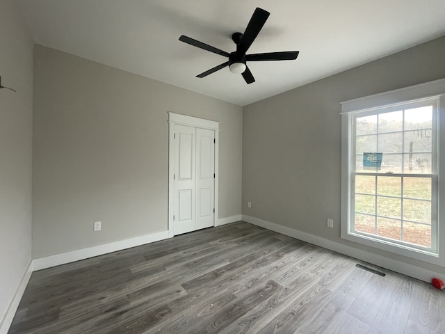 unfurnished bedroom with a closet, ceiling fan, and hardwood / wood-style floors