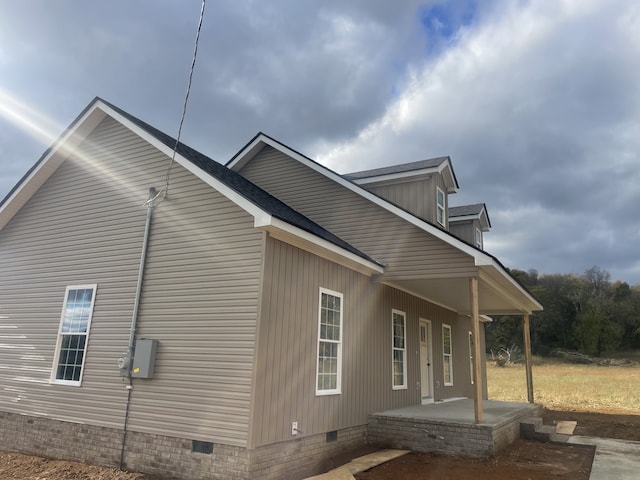 view of side of home featuring a porch