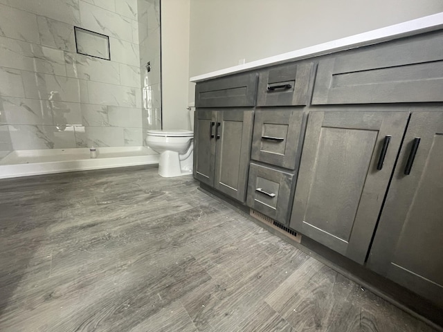 bathroom with toilet and tiled shower