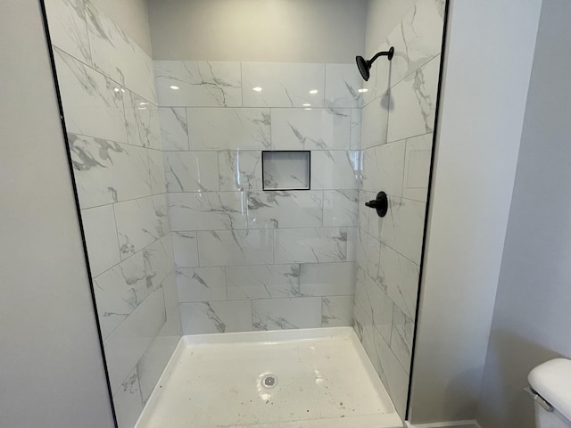 full bathroom with a shower stall and toilet