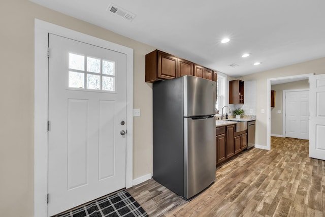 kitchen featuring hardwood / wood-style flooring and stainless steel appliances