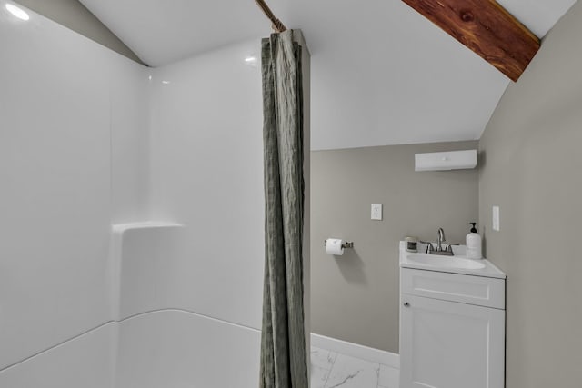 bathroom featuring vanity, curtained shower, and vaulted ceiling