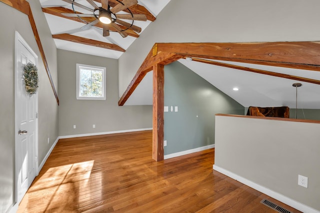 bonus room with ceiling fan, lofted ceiling with beams, and light wood-type flooring