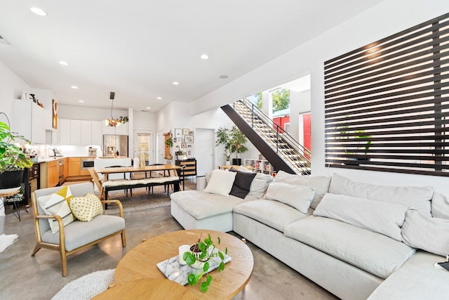 living room with a notable chandelier and sink